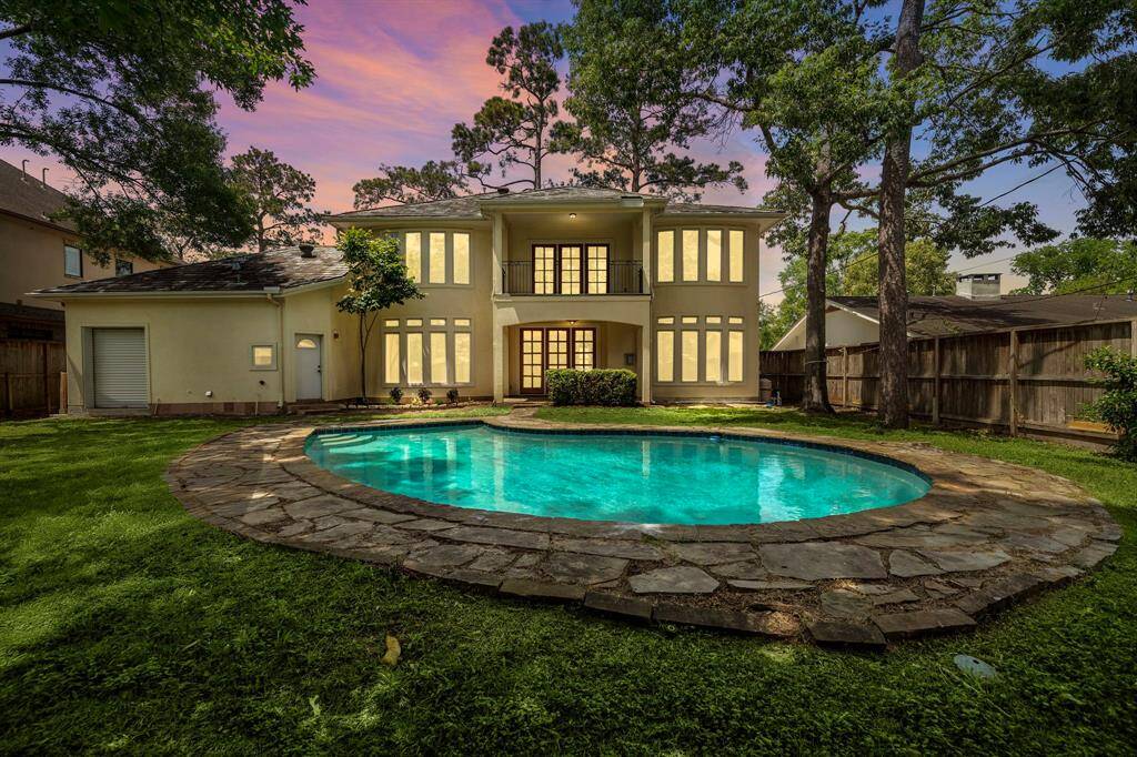Spacious backyard with sparkling pool. Garage has extra storage space and a bay door for easy access for lawn equipment, etc.
