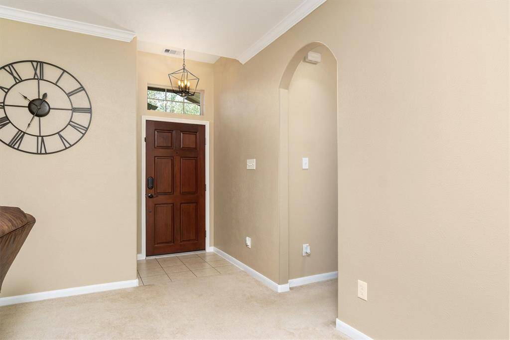 Welcoming entryway leads to the other two bedrooms or the garage