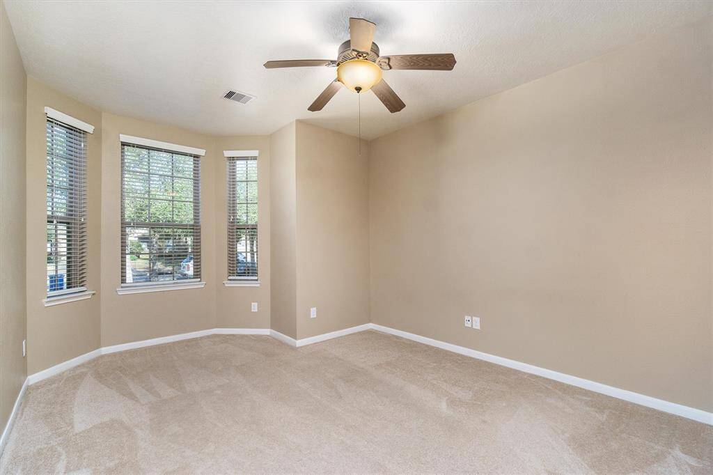 Second bedroom with bay window overlooks the front yard