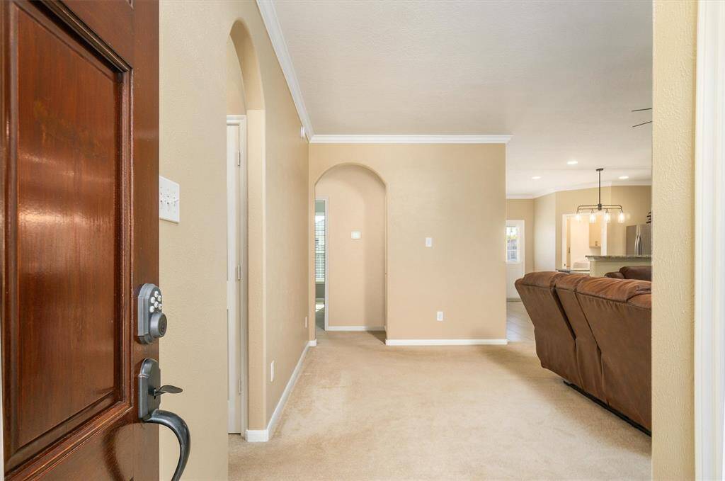 At entryway, you're met with beautiful archways leading to the bedrooms, living room area to your right.