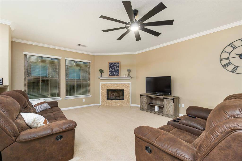 Cozy living room space with fireplace, new fan installed and fireplace surround. Glass doors added.