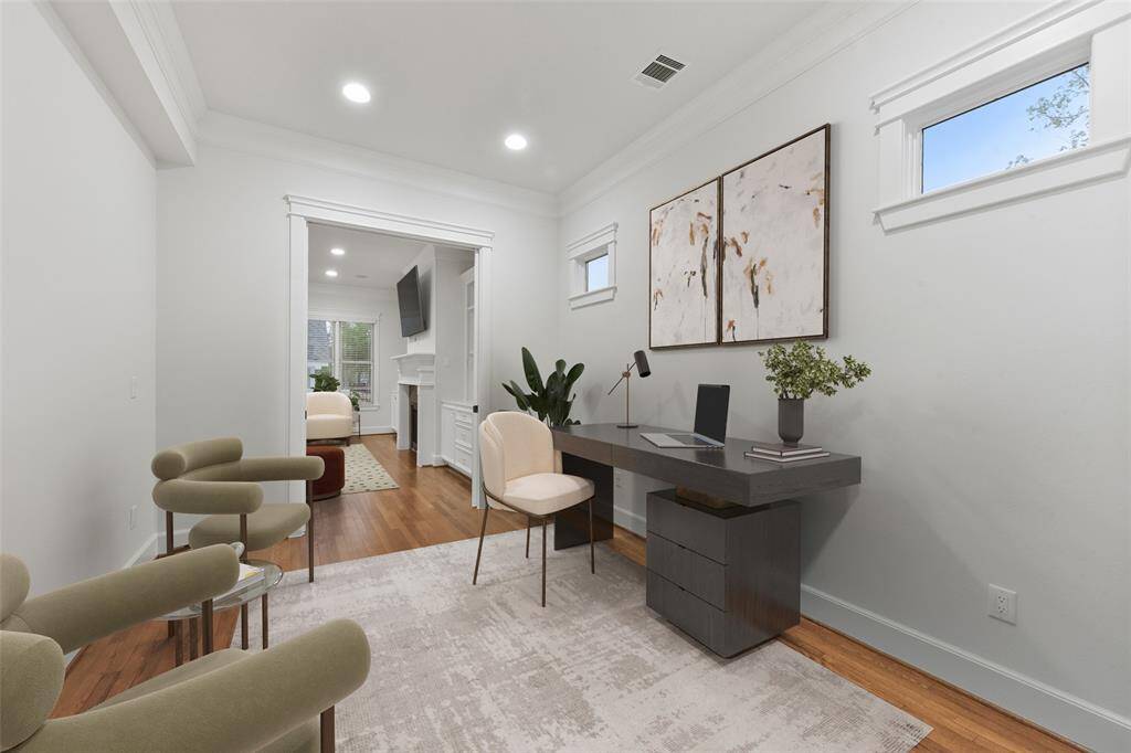 Bright and spacious study on the first floor with hardwood floors and recessed lighting features pocket doors opening to the Family room. Two small windows bring in an abundance of natural light. Virtually staged.