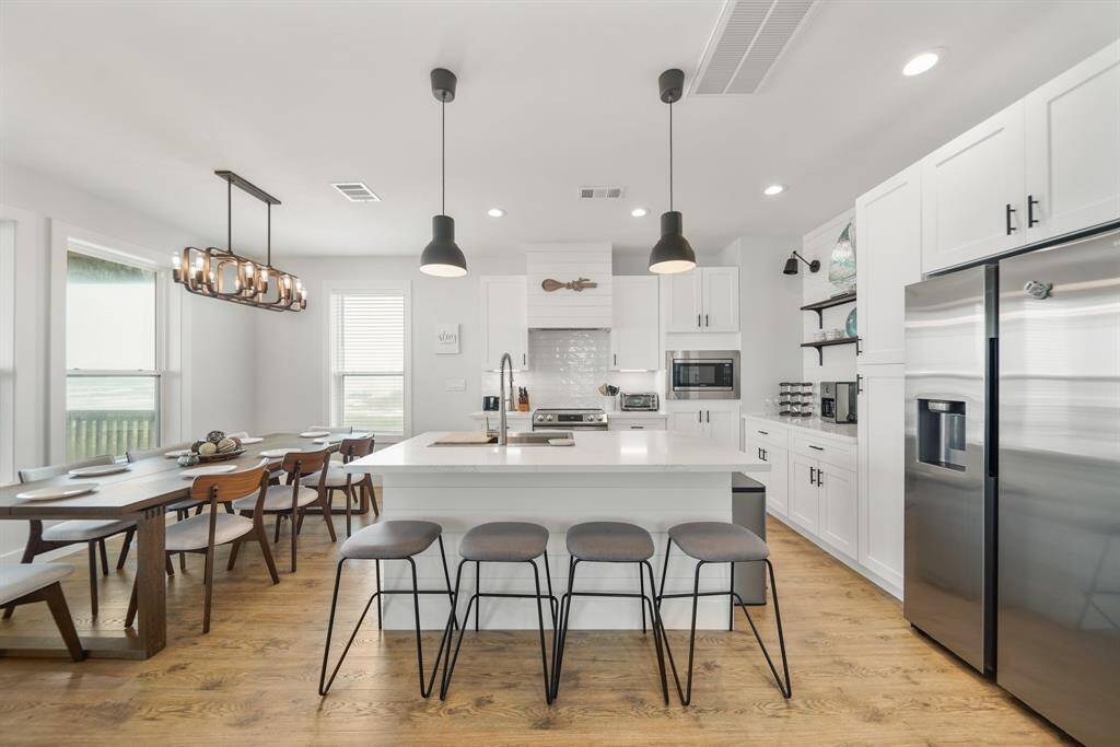 The kitchen, an integral part of thishome's open-concept design,seamlessly flows off the living room,creating a harmonious andconnected living space.
