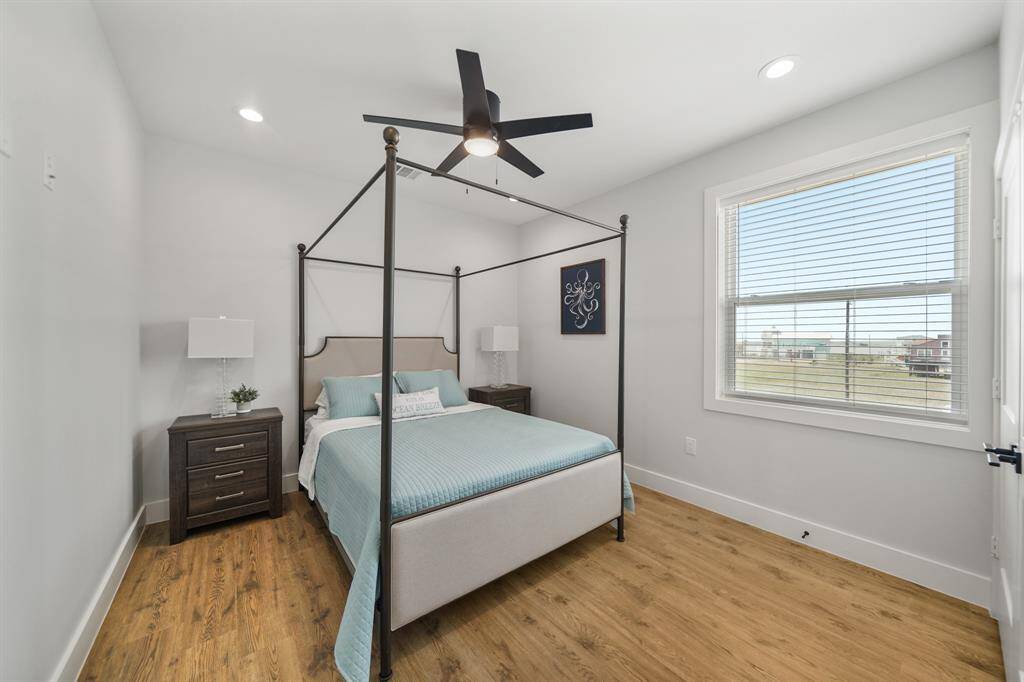 Primary bedroom features awindow and ceiling fan.