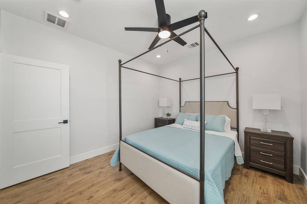 Primary bedroom features awindow and ceiling fan.