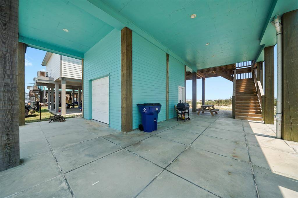This beach home has a covered patio and attached garage!