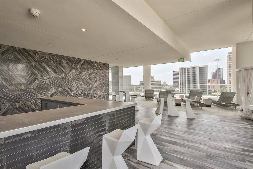 Covered outdoor kitchen by the pool available for resident use. One of several outdoor grilling areas.