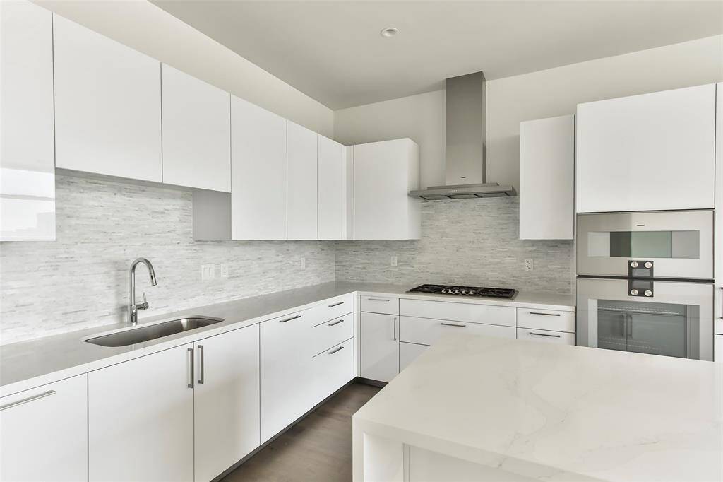State of the art kitchen features Eggersman soft close cabinetry, Gaggenau stainless steel appliances, gas cooktop, venta hood and wood floors. Countertops and gorgeous details throughout kitchen. Walk-In Pantry. Under Cabinet lighting.