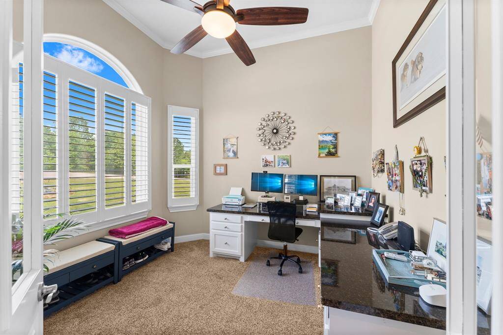 Office space will built-ins and a nice view of the front yard