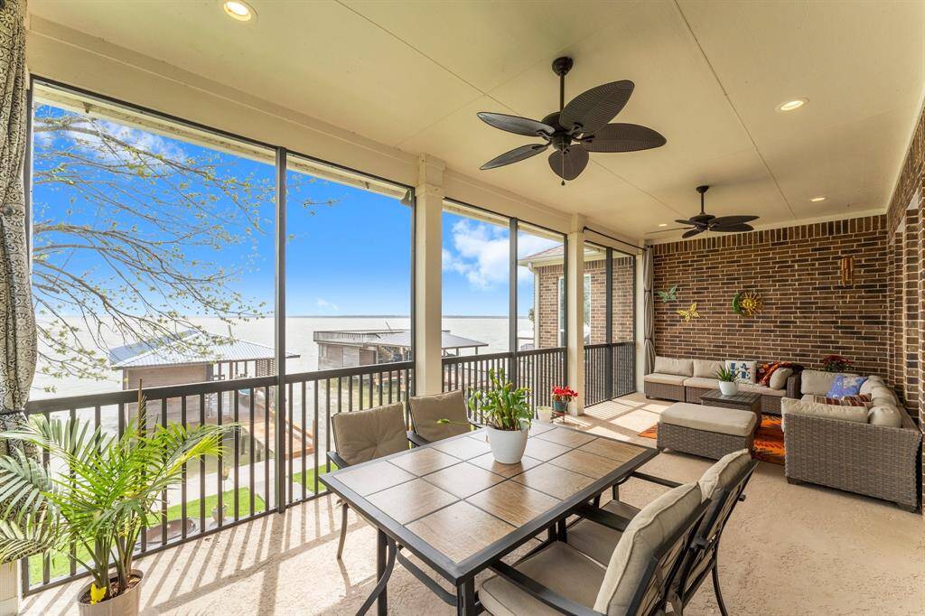 Main level screened porch with plenty of room for seating and dining