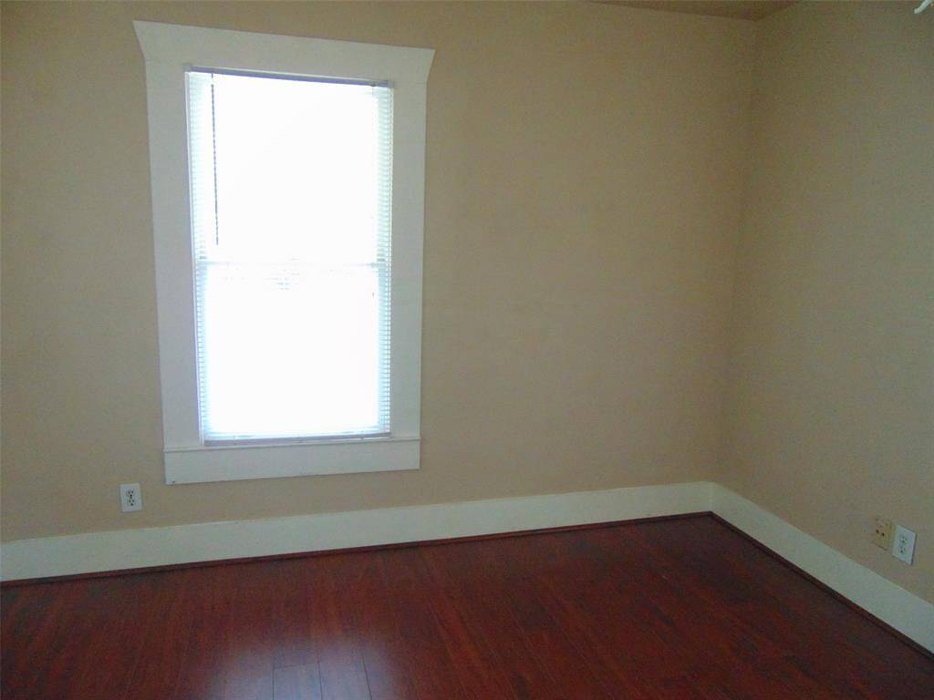 20 x 8 primary bedroom with real wood flooring and abundant natural light.