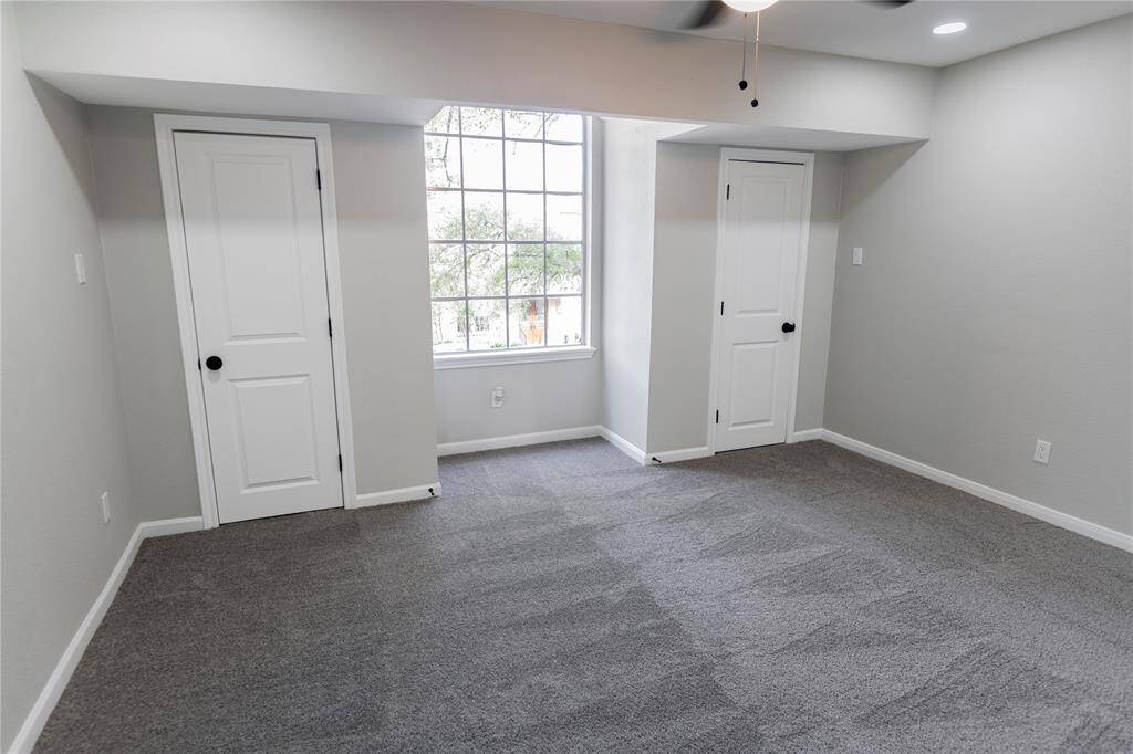 Bright bedroom with natural light and double closet.