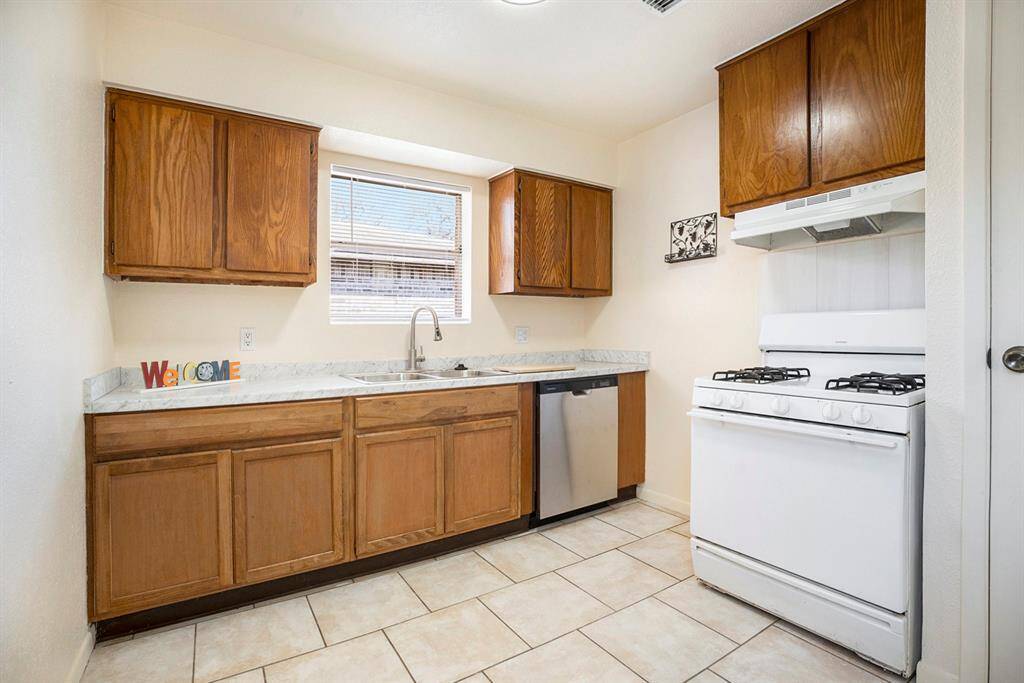 VIEW OF KITCHEN WITH GAS RANGE & DISHWASHER