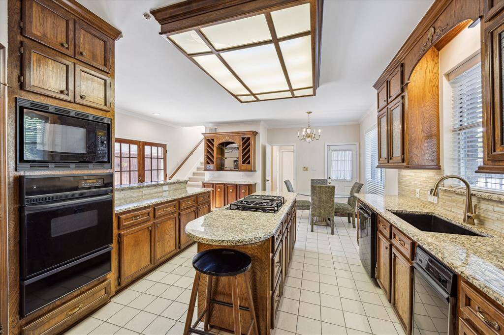 This spacious primary bedroom features vaulted ceilings, a large window with tree views, and a bright bay window area that fills the room with natural light.