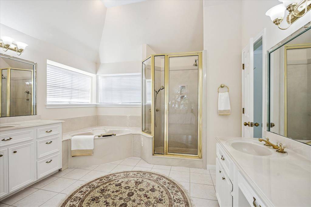 This secondary bedroom features vaulted ceilings, two closets, and a window that brings in natural light.