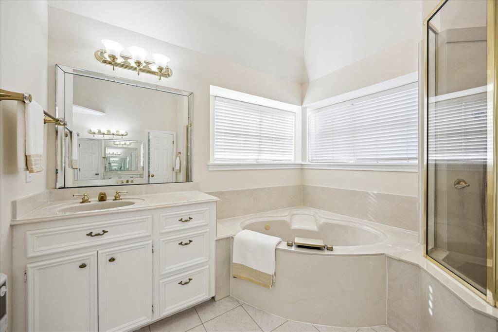 This secondary bedroom includes a built-in desk with upper storage and a window that lets in natural light.