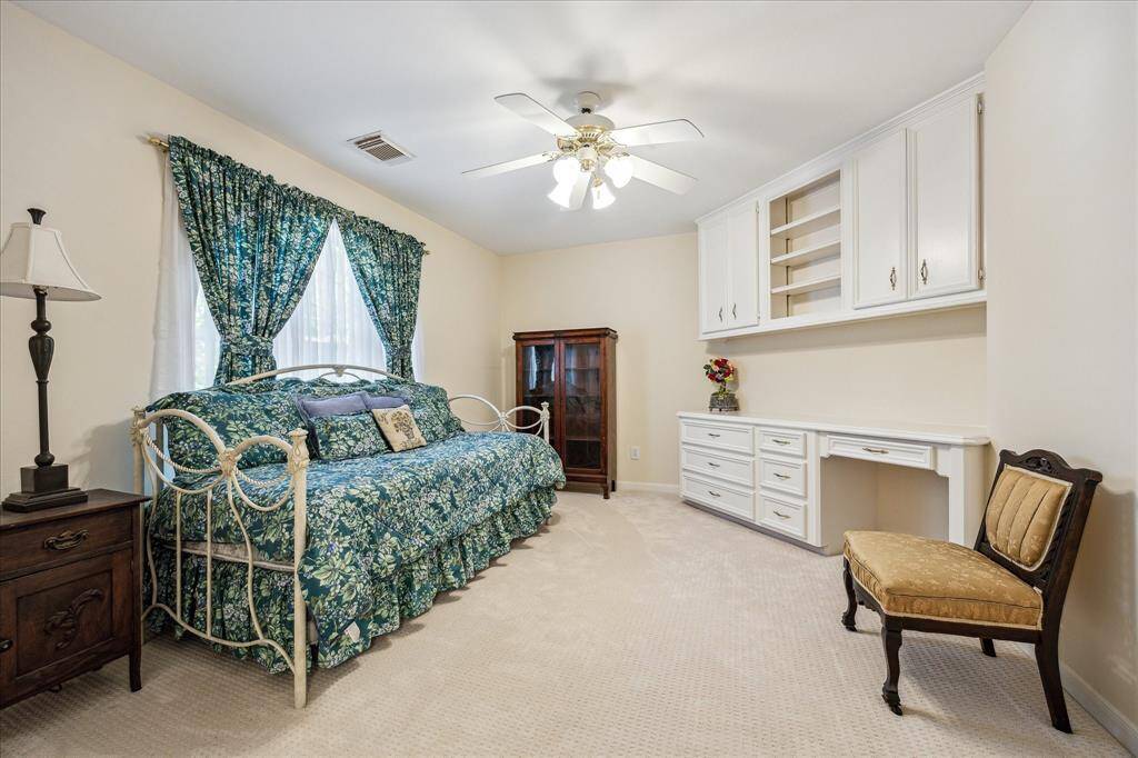 This expansive game room features vaulted ceilings with exposed beams, multiple windows for natural light, and access to a full bath.