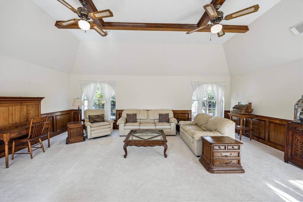 This secondary bedroom features a large arched window, neutral tones, and a double-door closet.