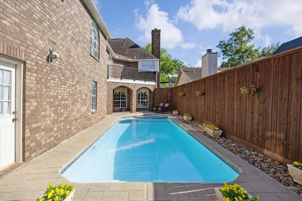 This gated side yard features a paved surface ideal for outdoor seating, with enough space to accommodate RV or boat storage.