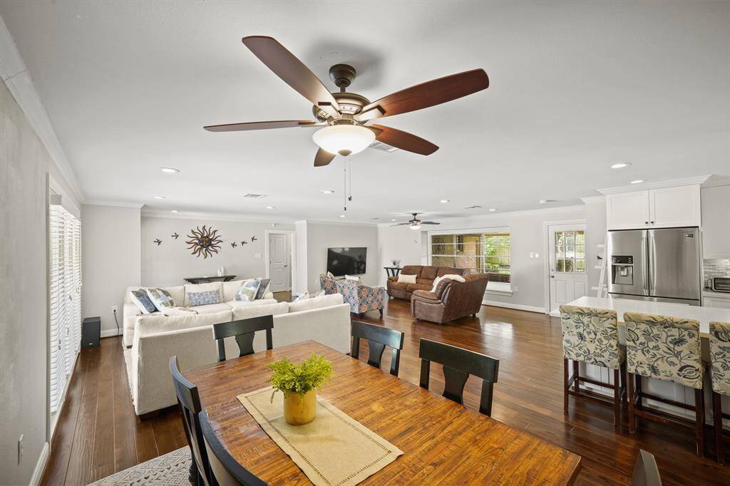 The Open Dining Area also offers an Updated Ceiling Fan with Wood Style Blades and Opaque Glass Shade.