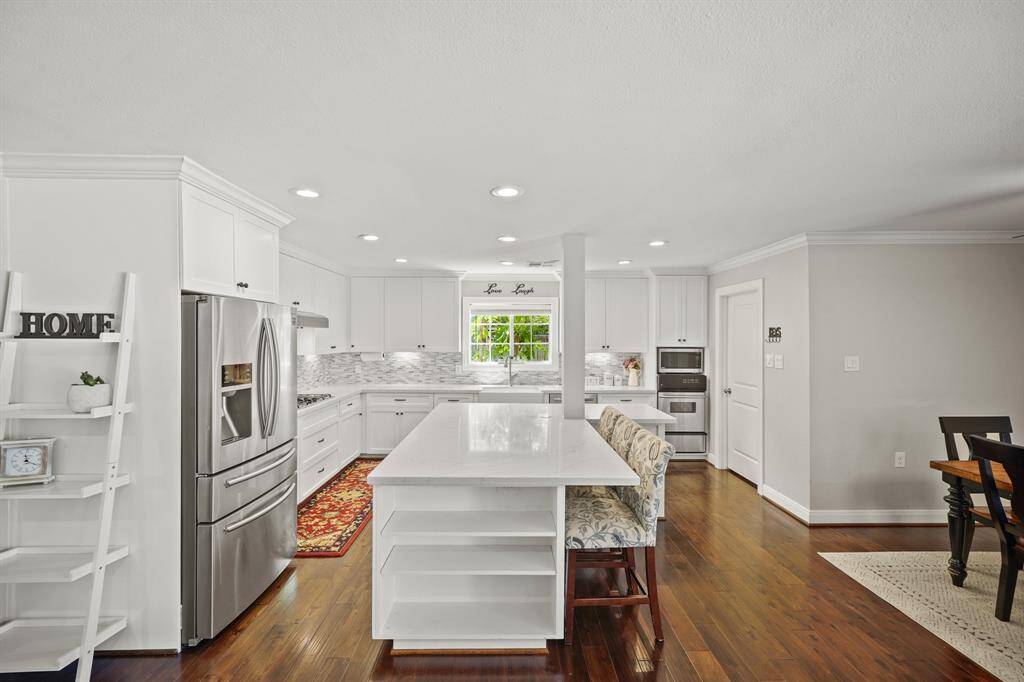 The Kitchen features a G.E. 5 Burner Gas Cooktop, G.E. Stainless Steel Vent Hood, KitchenAid Stainless Steel  Dishwasher, Stainless Steel Built in Microwave, and Light Grey Designer Paint with White Trim.