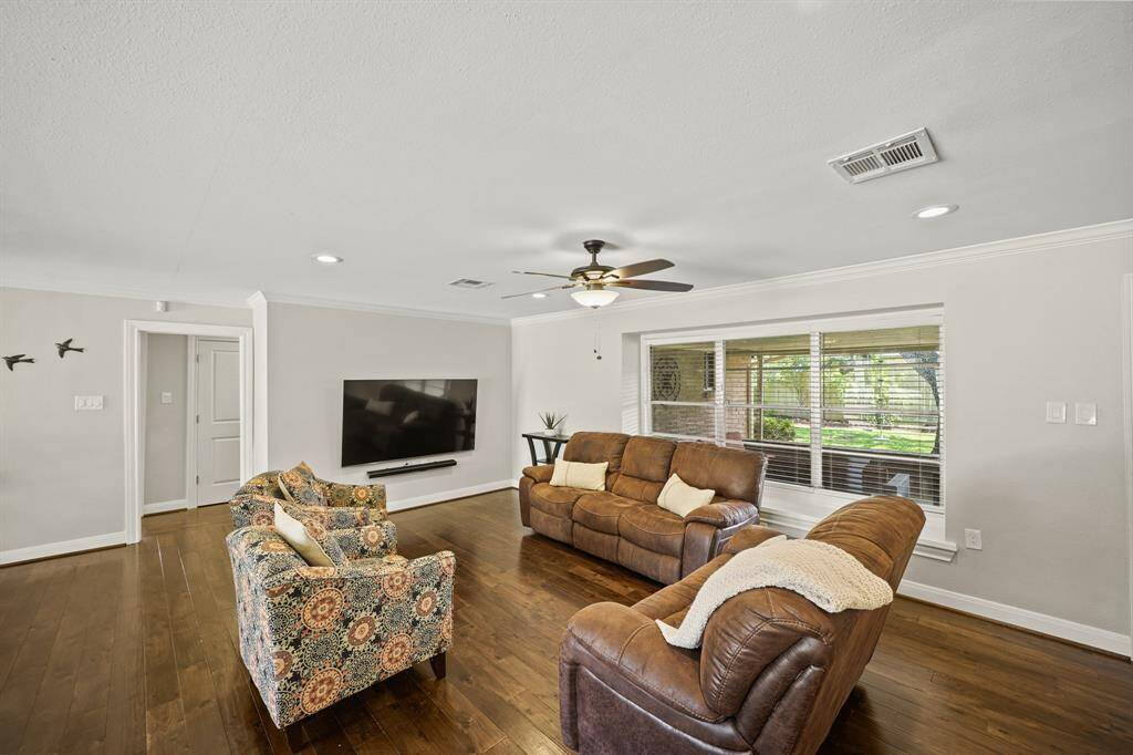 The Family Room offers a Bank of Windows that view the Landscaped Backyard and the Covered Patio.  Additional Amenities include a Built in Window Seat and Faux Wood Blinds.
