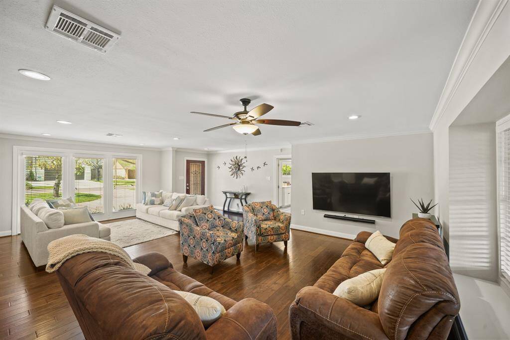 An Updated Ceiling Fan with Wood Style Blades and Opaque Glass Shade is also featured in the Family Room.