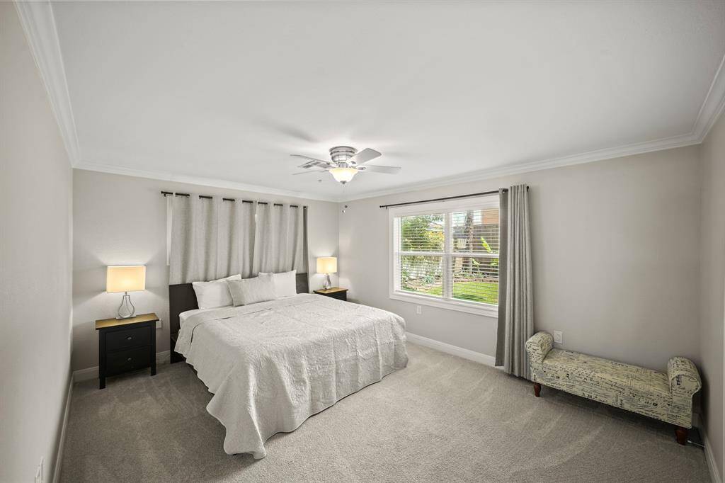 Updated Windows and Grey Hued Fabric Tab Drapes are featured in the Primary Bedroom.