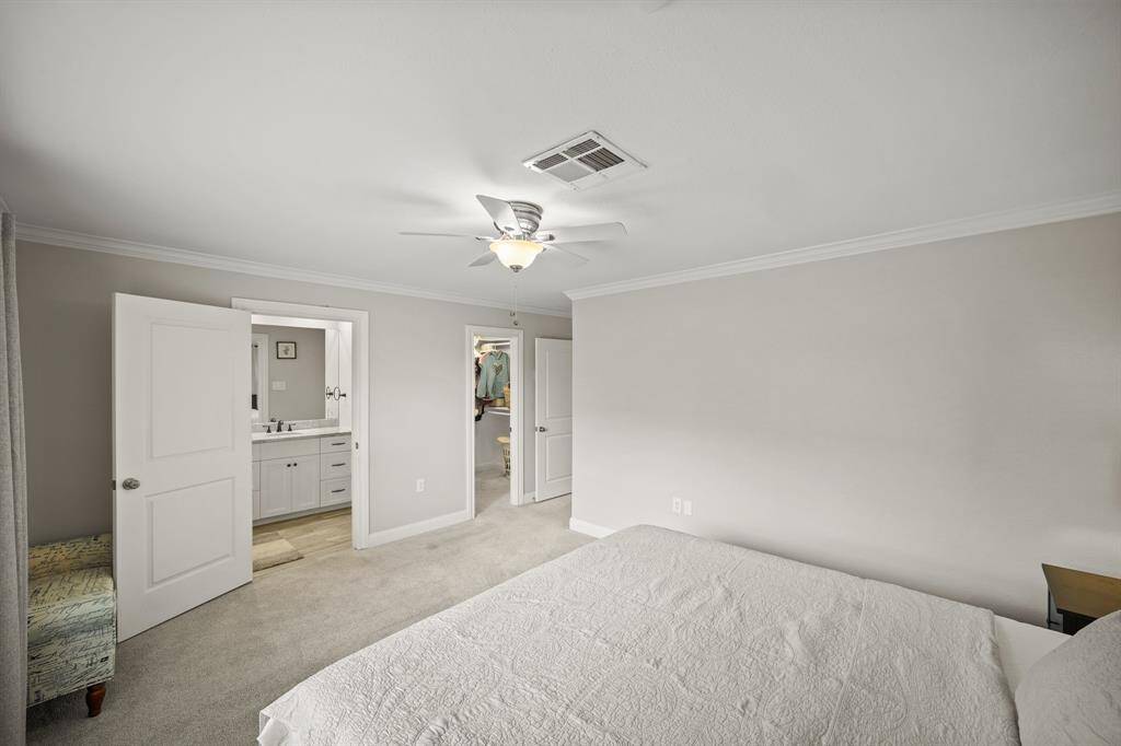 The Primary Bedroom offers a Walk in Closet (Approximately 7'3" x 5'7") with Built in Shelves, Multiple Hanging Rods, and Flush Mount Light Fixture.