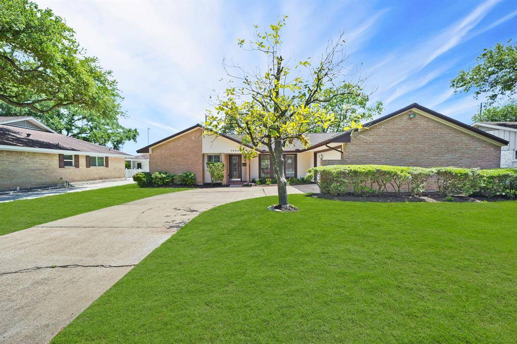 The Welcoming Front Porch features a Brick Tiled Floor, Treated Metal Coach Light, Ring Doorbell, Decorative Brick Wall with Dual Architecturally Inspired Openings, and an Elecric Outlet (with Cover).