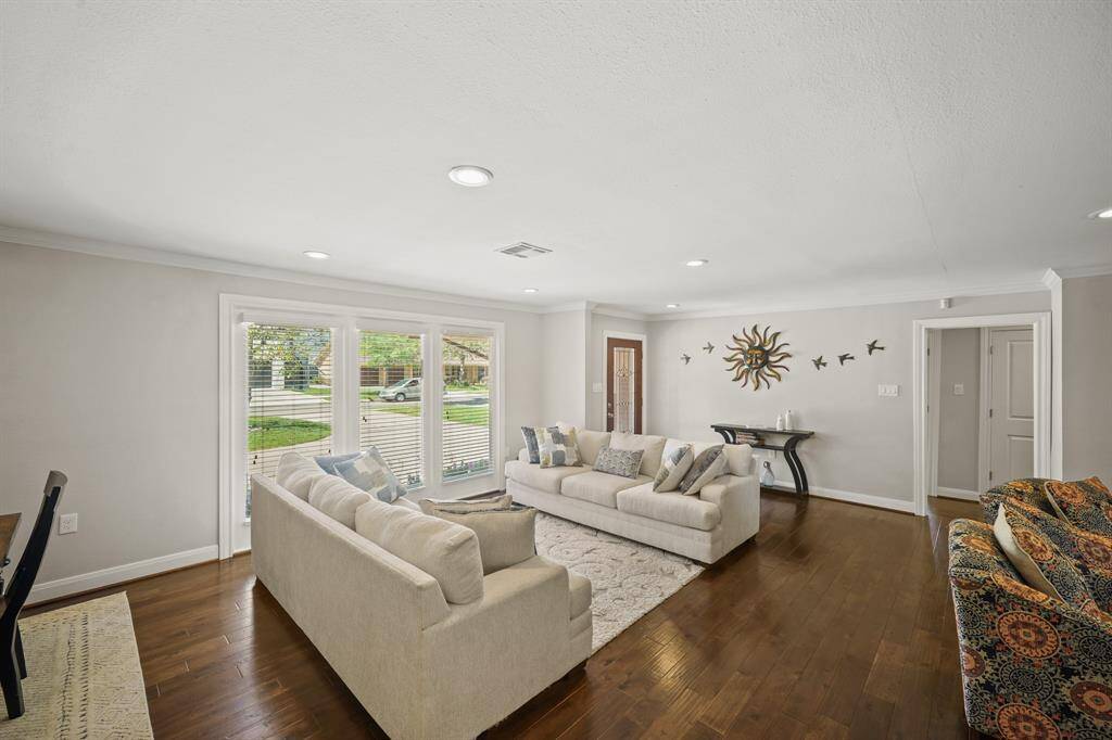 Triple Stationary French Style Doors in the Living Area/Den view the Landscaped Front Yard.