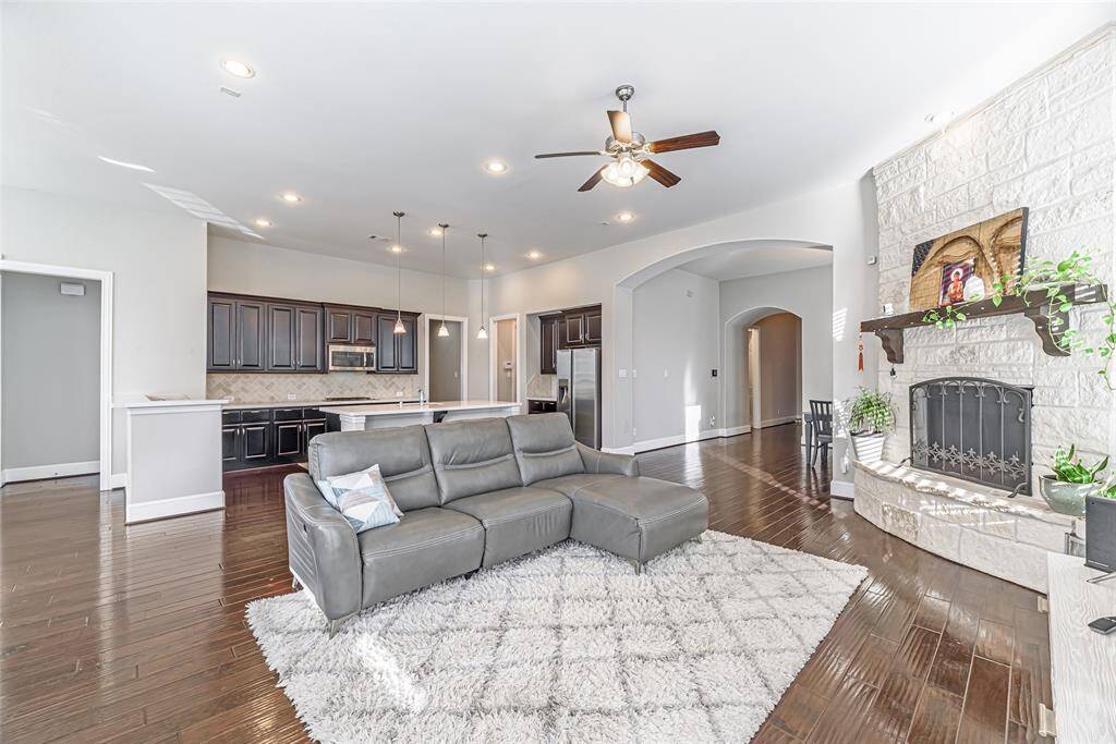 Formal living room with wood floors, recessed lighting, and ceiling fan.