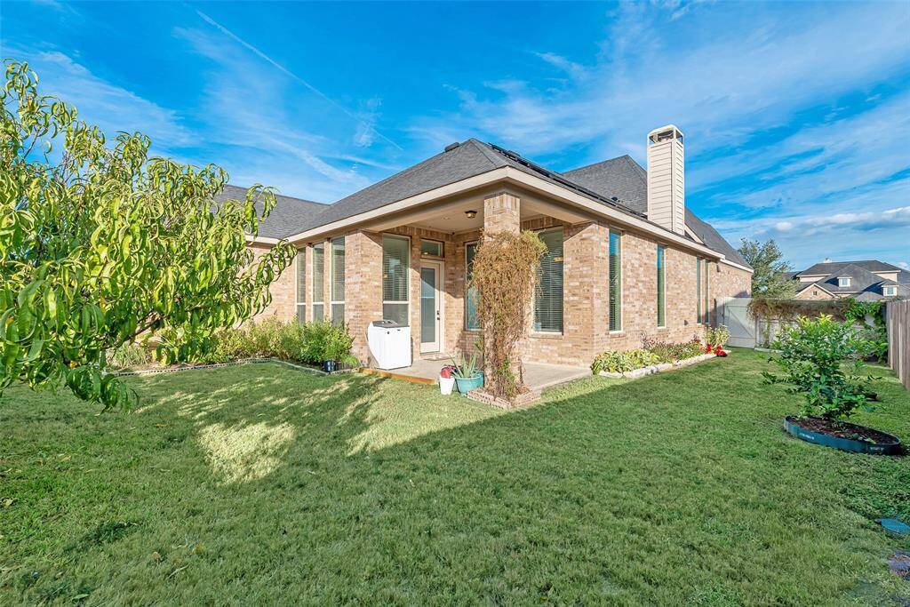 Spacious wrap around backyard with a covered patio.