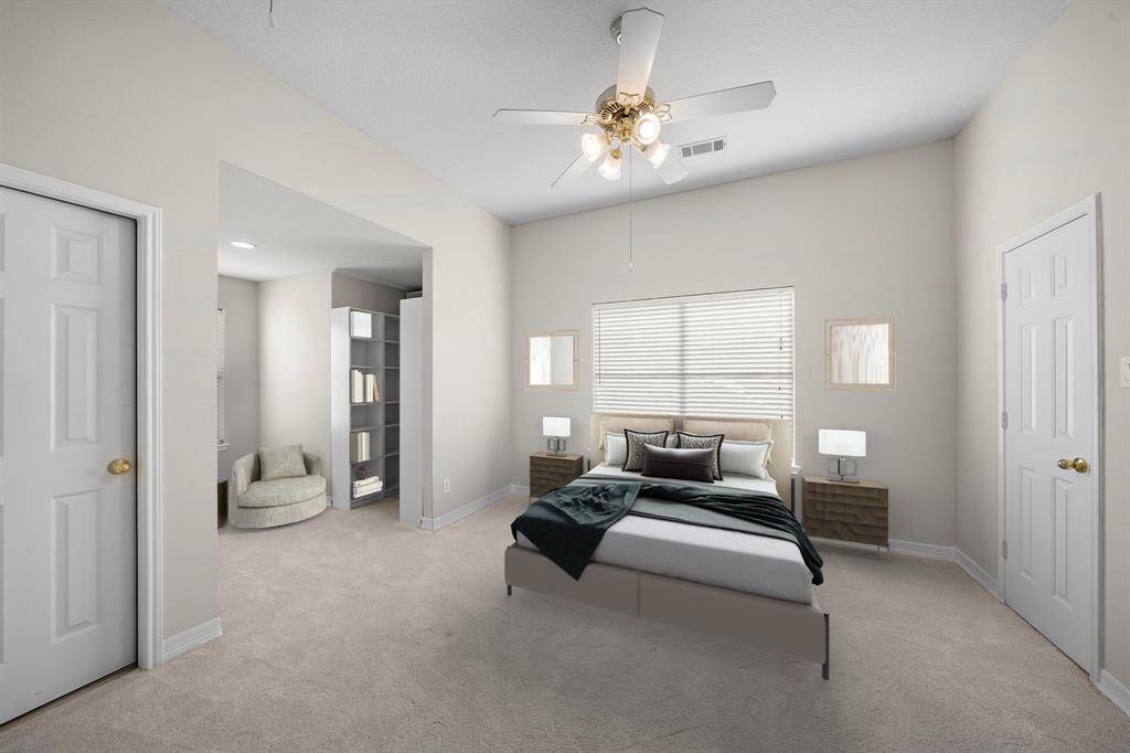Generous in size, this secondary bedroom offers dual closets and an alcove sitting area, making it ideal for guests or multi-use flexibility. This photo has been virtually staged.