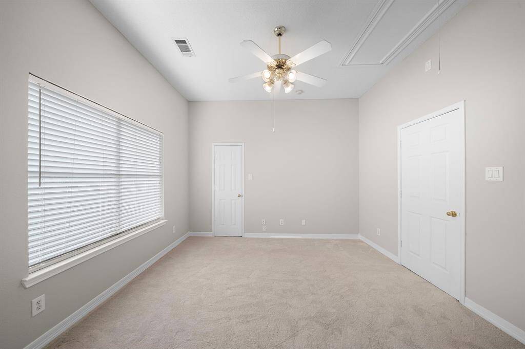 With tall ceilings, carpeted floors, and flexible wall space, this bedroom is move-in ready and adaptable to a range of styles.
