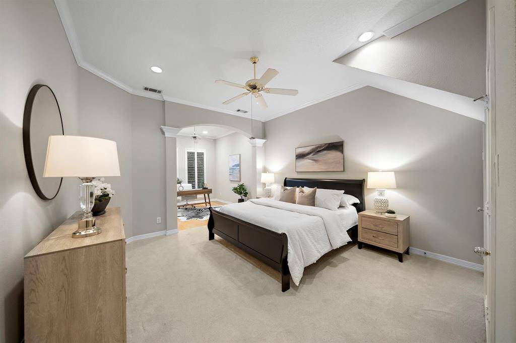 The spacious primary suite offers a serene escape with a sitting nook ideal for quiet mornings or late-night reads. Tray ceilings, plush carpeting, and a walk-in closet complement the ensuite bath’s thoughtful updates.