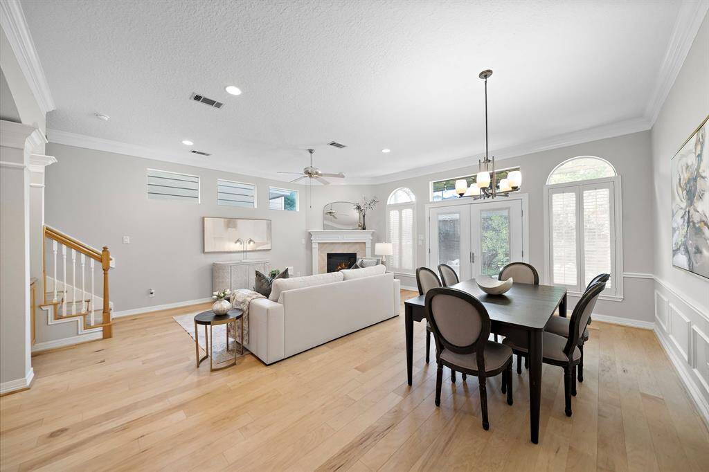 Soaring ceilings and arched transom windows elevate this airy gathering space, where classic millwork and recessed lighting add polish throughout.