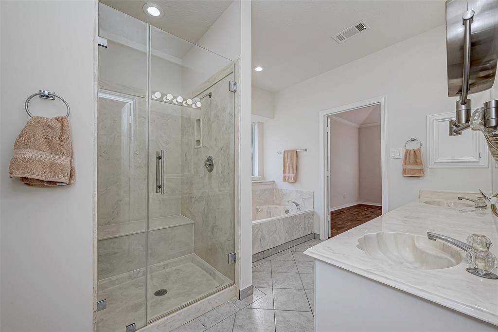 Seamless glass shower door in primary bath