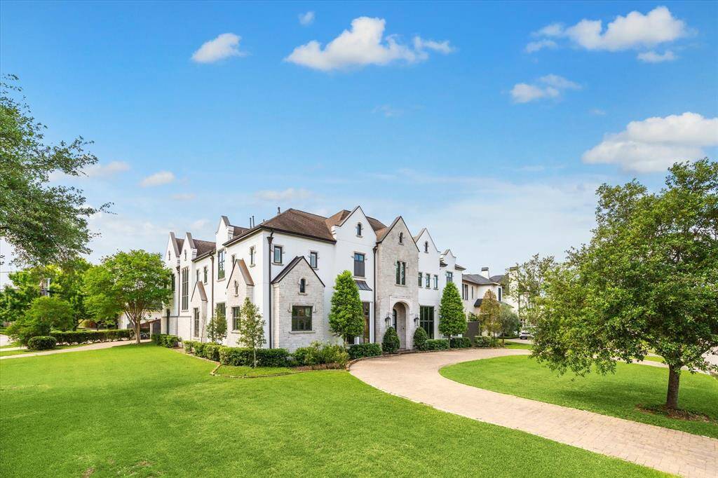 Situated on an expansive 17,440 SF corner lot in prestigious Tanglewood.