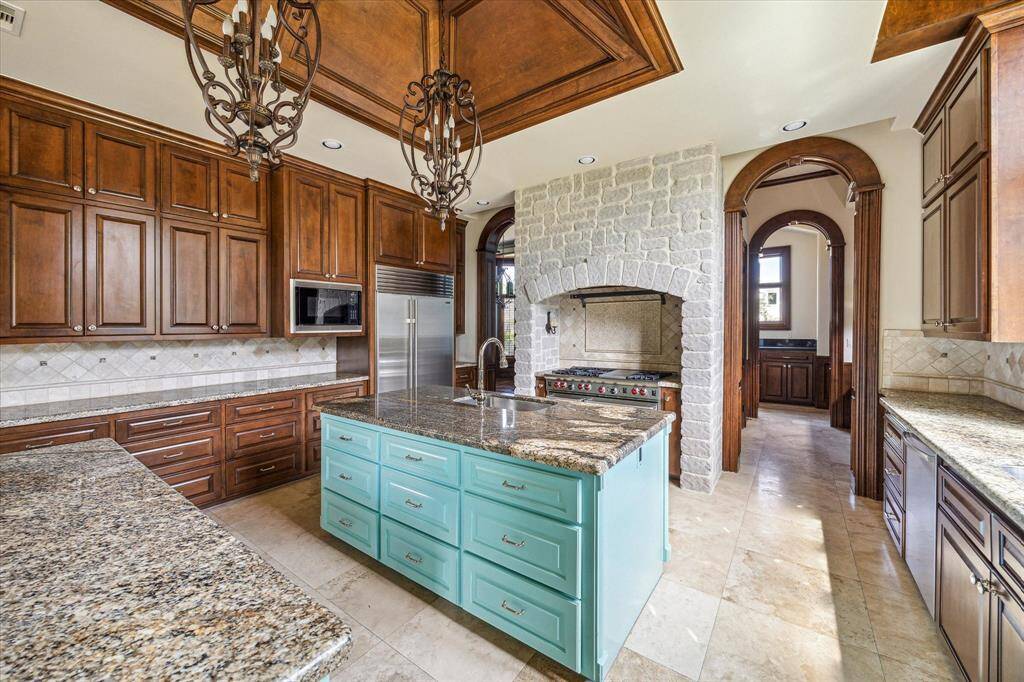 The chef’s kitchen with dual sinks, dual dishwashers, 48" Wolf gas range with dual ovens and a Sub Zero refrigerator.