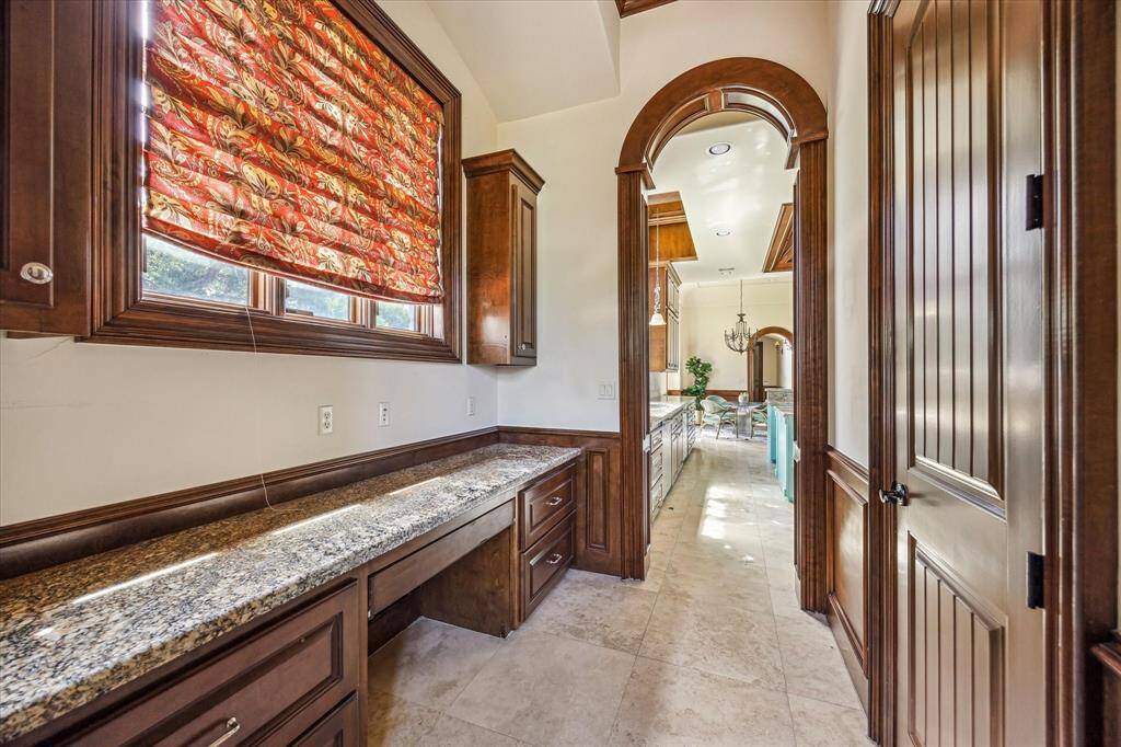 This butler's pantry connects the kitchen and formal dining room. The door on the right is the walk-in pantry.