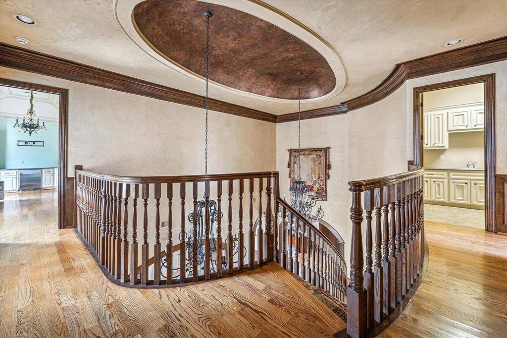Heading upstairs, you'll find the primary suite on the left and utility room on the right.