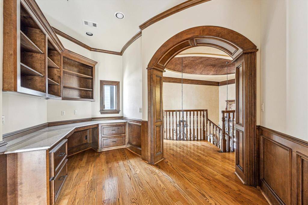 Heading toward the back of the home, you'll find a built-in work area just off of the game room upstairs.