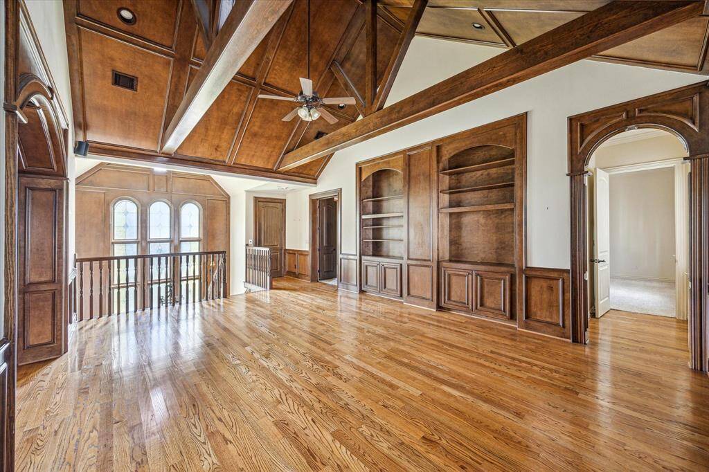 This expansive flex space is ideal for a game room! The front staircase is to the left, and the back staircase is straight ahead.
