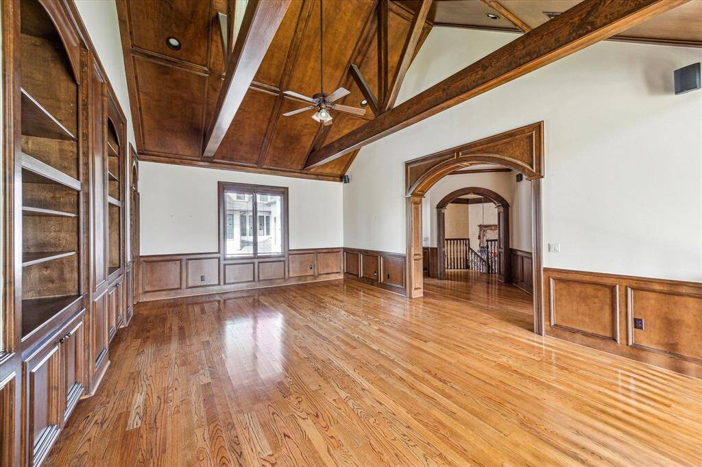 Another view of the game room, looking toward the front staircase and built-in workspace.