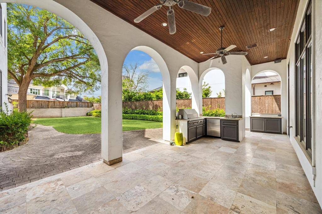 The covered patio is equipped with a gas grill, beverage fridge, and sink. It is perfect for outdoor entertaining!
