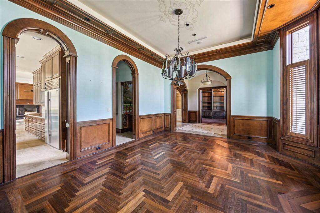 Another view of the formal dining room. Head to the kitchen on the left or the study on the right. The middle archway leads to a stunning wet bar with tons of wine storage!