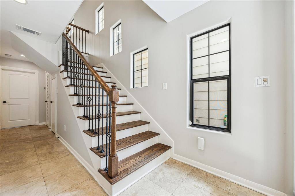 First floor entrance features natural light and a private first floor bedroom and en-suite bath.