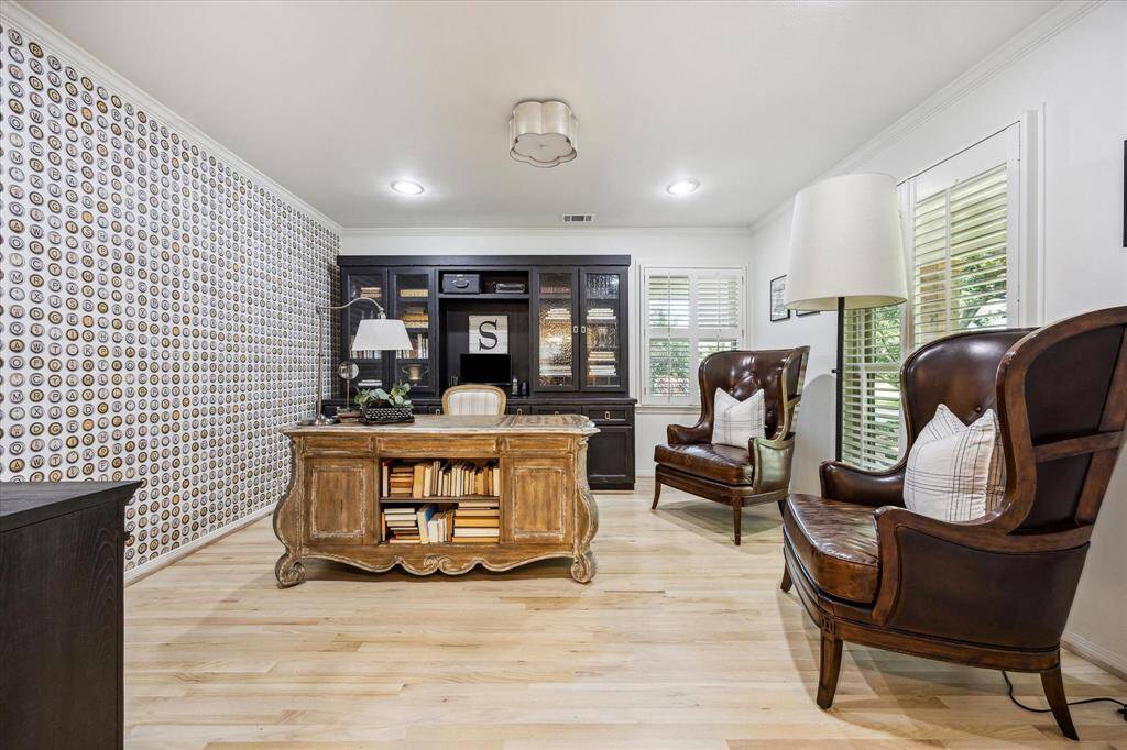 This photo showcases a stylish home office. The room is well-lit with natural light from the windows, creating a cozy and productive atmosphere.