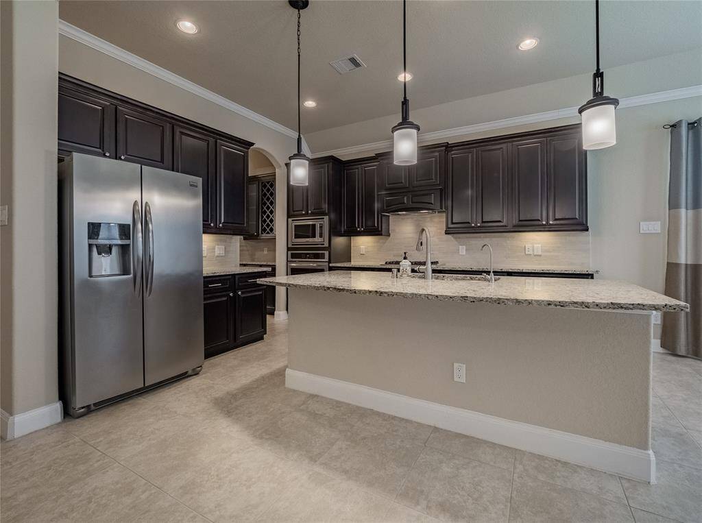 just off the kitchen between the formal dining and kitchen you has a small wine bar, coffee station also called a butlers pantry